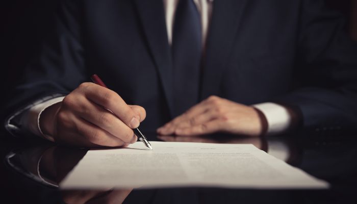 lawyer writing liability waiver