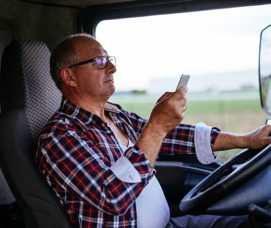truck driver distracted on his phone