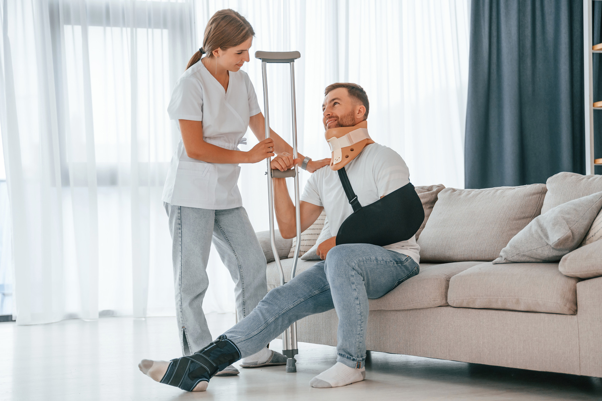 nurse is helping injured man at home