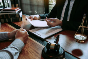 Lawyer explains legal papers across a desk