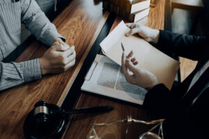 Legal discussion with envelope and documents on clipboard