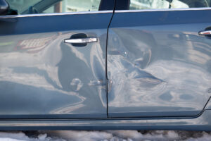 sheet-metal-damage-to-blue-car-in-a-car-accident