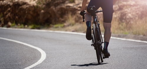 Photo of someone riding a bicycle on the road